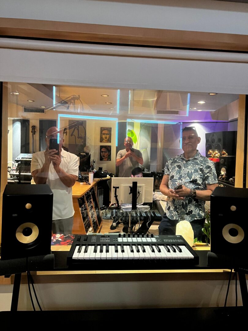 Recording studio keyboard and three men